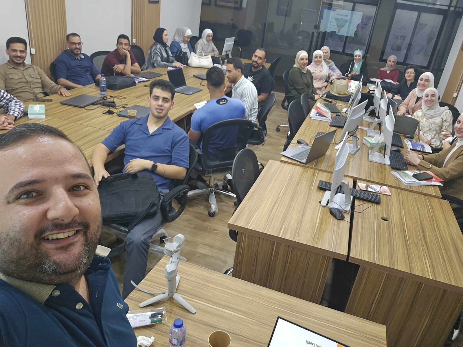 Participants gathered around computers during a digital marketing and AI training session
